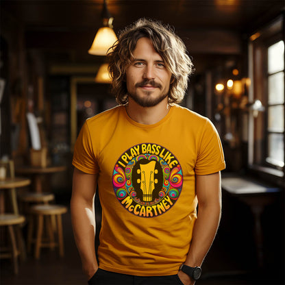 Unisex yellow t-shirt featuring "I Play Bass Like McCartney" graphic with colorful psychedelic design.