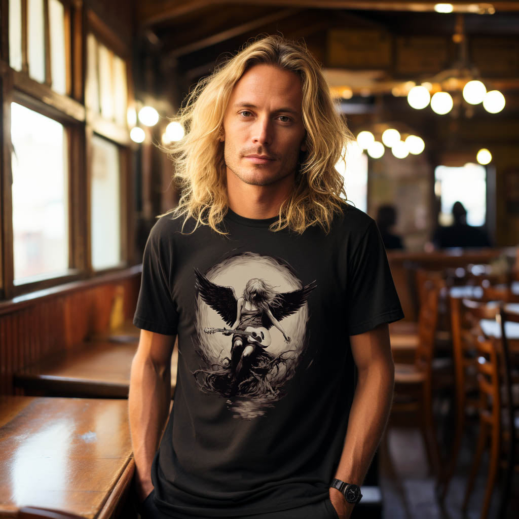 A long-haired blond man wearing a black t-shirt with an angel with open wings playing a left handed acoustic guitar.