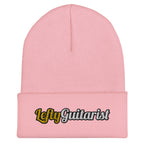 Cuffed baby pink beanie featuring "LeftyGuitarist" logo in black and gold on the front.
