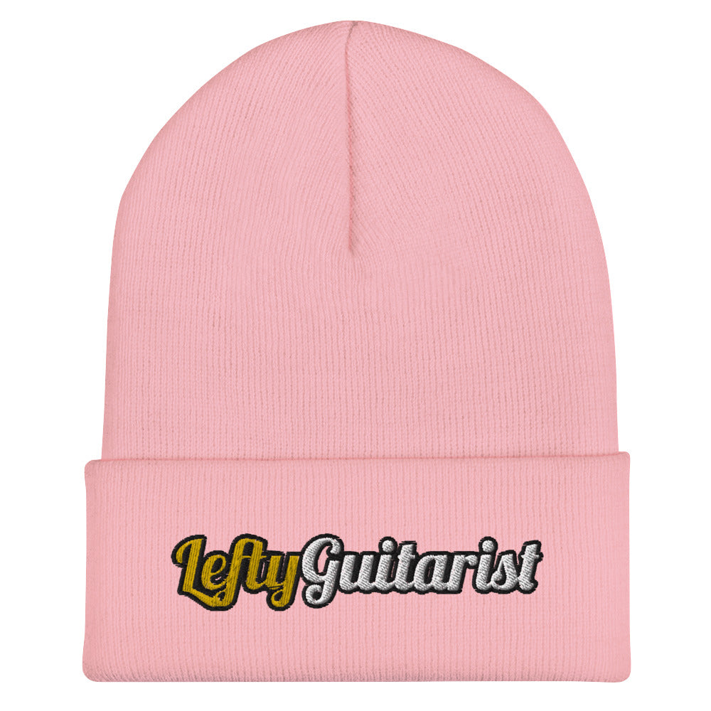 Cuffed baby pink beanie featuring "LeftyGuitarist" logo in black and gold on the front.