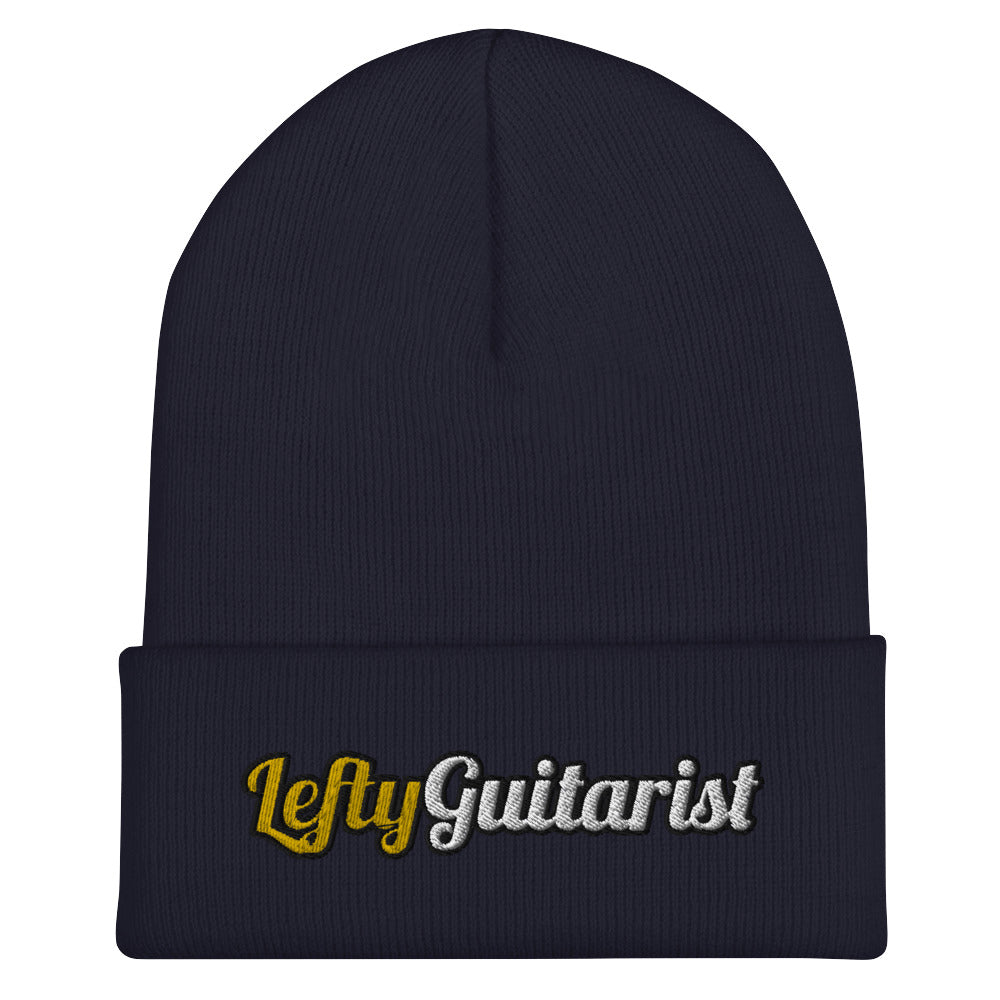Navy cuffed beanie featuring the embroidered text "LeftyGuitarist" in gold and silver.