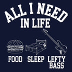 Navy t-shirt design featuring "All I Need in Life - Food, Sleep, Lefty Bass" in white text with icons of a burger, bed, and lefty bass guitar.