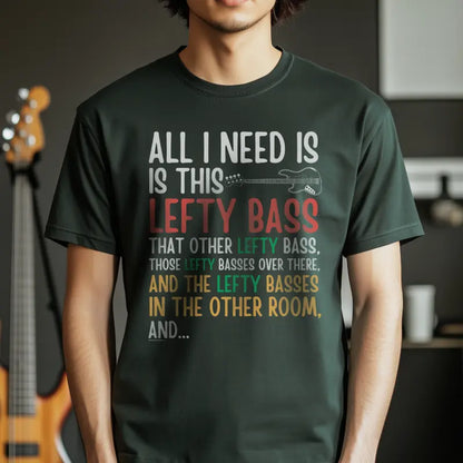 Forest green t-shirt with "All I Need Is This Lefty Bass" text and lefty bass guitar graphic in multiple colors.