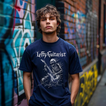 LeftyGuitarist "Skeleton" unisex t-shirt in navy featuring a skeleton playing lefty guitar, worn by a model against a graffiti background