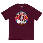Maroon unisex t-shirt featuring a colorful graphic that reads "I play guitar like HENDRIX" with a guitar headstock illustration.
