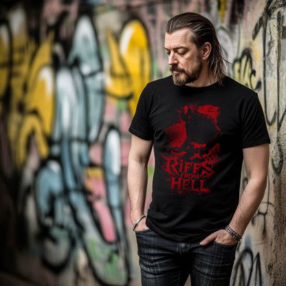 Black unisex t-shirt featuring a red graphic of a lefty demon guitarist with the text "Riffs From Hell," worn by a man standing in front of a graffitied wall