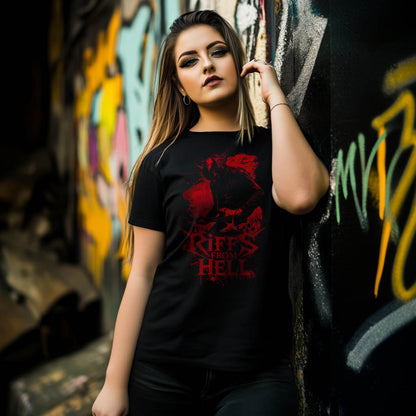A woman standing in front of a graffitied wall, wearing a black unisex T-shirt featuring a red graphic of a lefty demon guitarist with the text "Riffs From Hell.