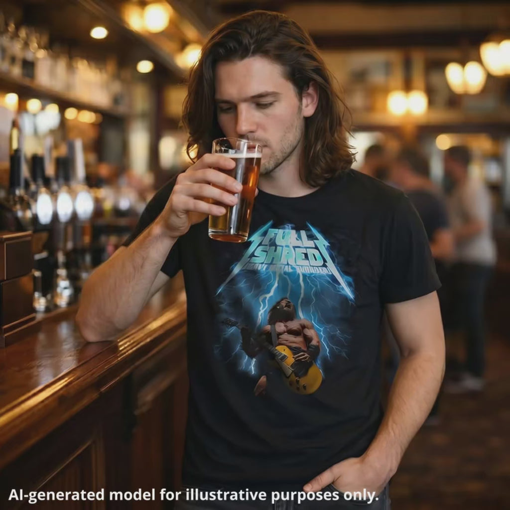 Man wearing a black unisex T-shirt featuring a muscular man playing a lefty gold top Les Paul style guitar, with "Full Shred Heavy Metal Thunder" text and lightning design.