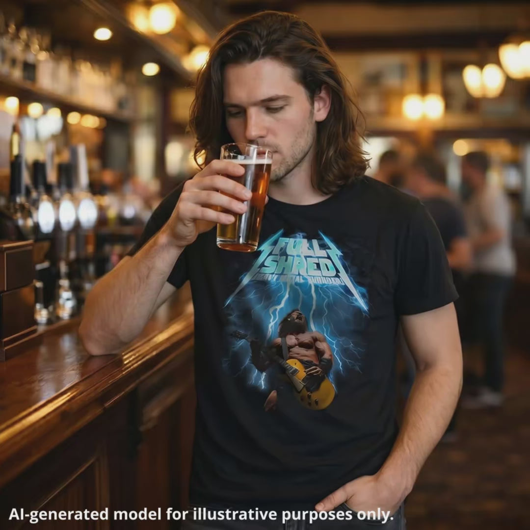 Man wearing a black unisex T-shirt featuring a muscular man playing a lefty gold top Les Paul style guitar, with "Full Shred Heavy Metal Thunder" text and lightning design.