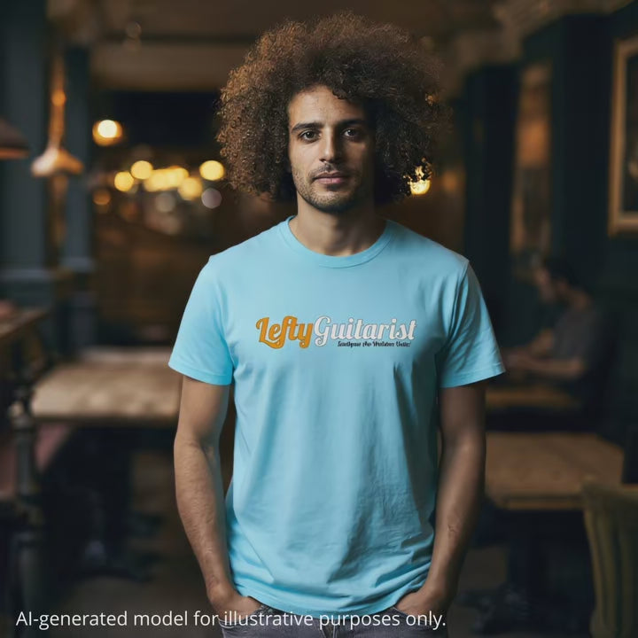 Man wearing a light blue unisex t-shirt featuring the "LeftyGuitarist" logo in orange and white across the front.