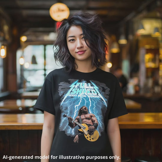 Woman wearing a black unisex T-shirt featuring a muscular man playing a lefty gold top Les Paul style guitar, with "Full Shred Heavy Metal Thunder!" text and lightning design.