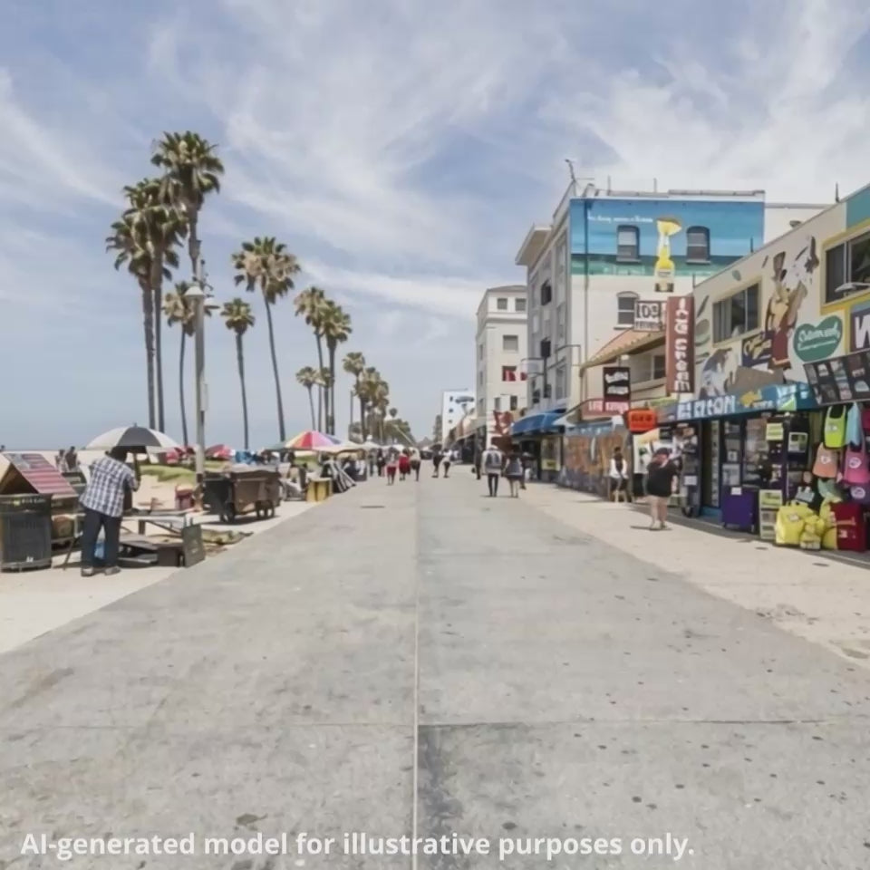 A woman with strawberry blonde hair walks onto the sidewalk along Venice Beach, LA, CA. She is wearing a black graphic t-shirt featuring a rock guitarist illustration playing a lefty electric guitar.