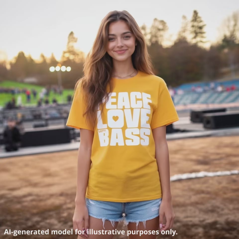 American-Greek woman with long brown hair wearing a yellow unisex T-shirt featuring a large block of white text that reads "PEACE LOVE LEFTY BASS".