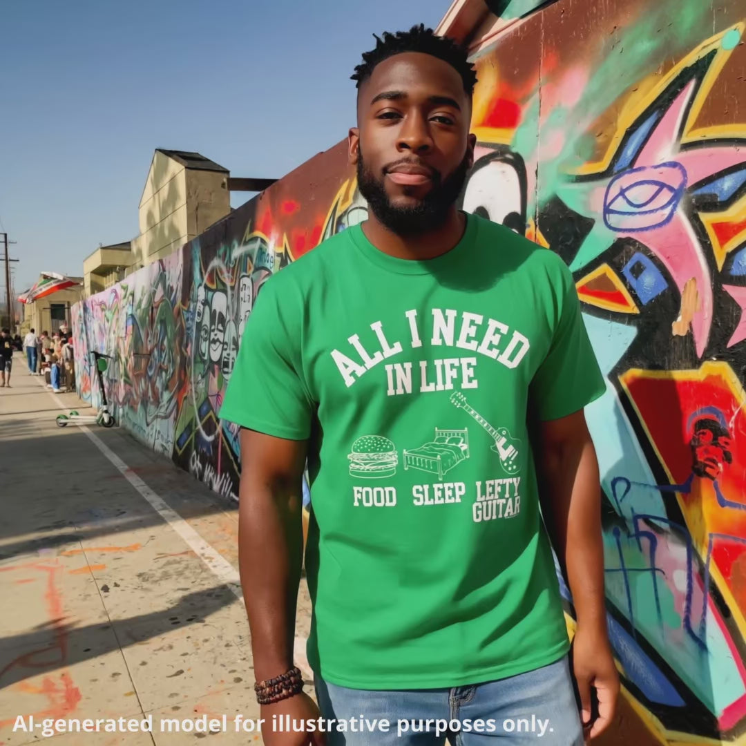 Green unisex T-shirt featuring the text "All I Need in Life - Food, Sleep, Lefty Guitar" with icons of a burger, bed, and a lefty guitar