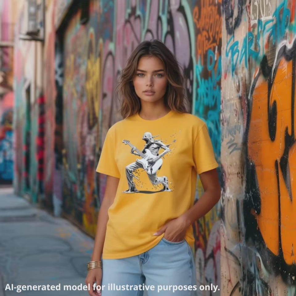 A woman wearing a yellow-gold colored t-shirt with "The Lefty Melting Man" design, featuring a surreal, melting figure playing a white left handed electric Strat-type guitar.