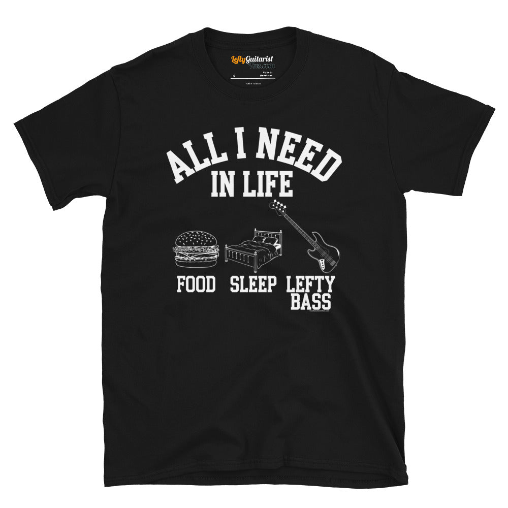 Black unisex t-shirt featuring the white text "All I need in life - food, sleep, lefty bass" with icons of a burger, bed and a left handed bass guitar.