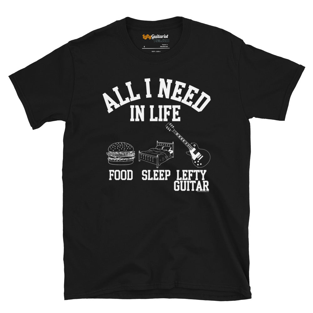 Black unisex t-shirt featuring the phrase "All I Need in Life - Food, Sleep, Lefty Guitar" with graphics of a burger, bed and left handed guitar.
