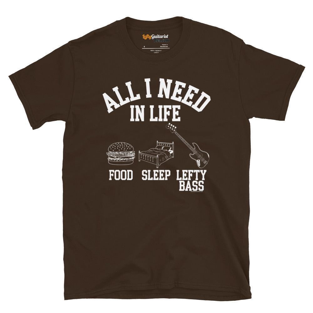 Dark chocolate unisex t-shirt featuring the white text "All I Need in Life - Food, Sleep, Lefty Bass" with icons of a burger, bed and a left handed bass guitar