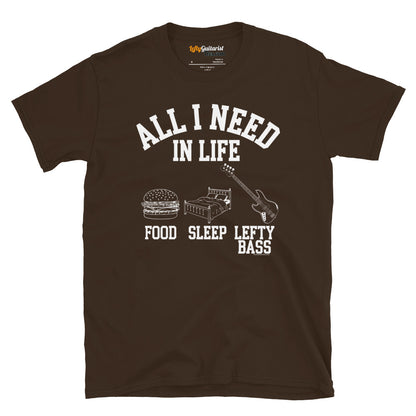 Dark chocolate unisex t-shirt featuring the white text "All I Need in Life - Food, Sleep, Lefty Bass" with icons of a burger, bed and a left handed bass guitar