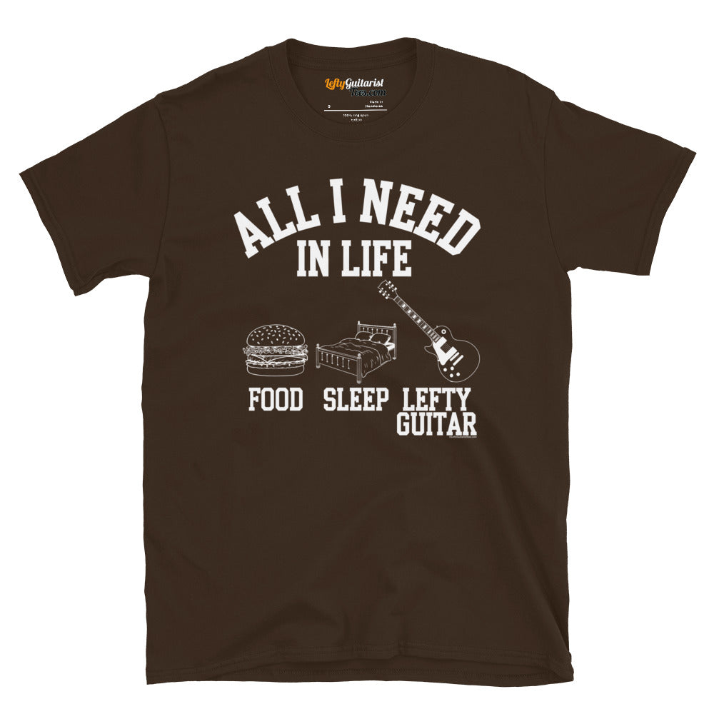 Dark chocolate unisex t-shirt featuring the text "All I need in life - food, sleep, lefty guitar" with icons of a burger, bed and left handed guitar..