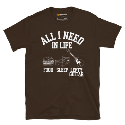 Dark chocolate unisex t-shirt featuring the text "All I need in life - food, sleep, lefty guitar" with icons of a burger, bed and left handed guitar..