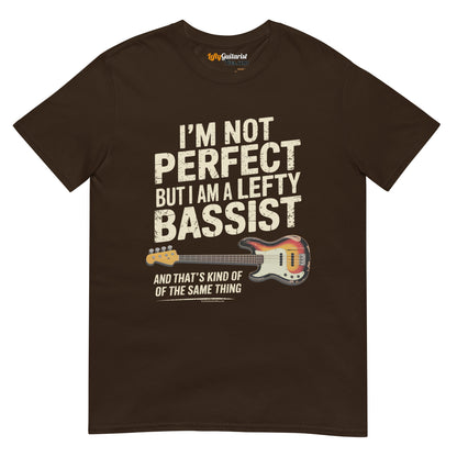 Dark chocolate unisex t-shirt featuring the text "I'm not perfect but I am a lefty bassist" and a lefty bass guitar graphic.
