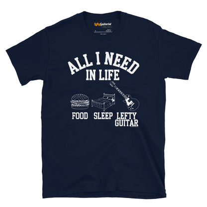 Navy unisex T-shirt featuring the text "All I need in life - food, sleep, lefty guitar" with graphics of a burger, bed and left handed guitar.