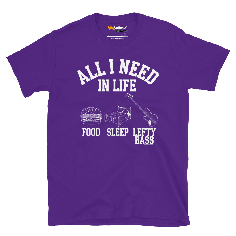 Purple unisex T-shirt featuring the white text "All I need in life - food, sleep, lefty bass" with icons of a burger, bed and a left handed bass guitar