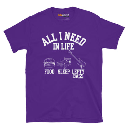 Purple unisex T-shirt featuring the white text "All I need in life - food, sleep, lefty bass" with icons of a burger, bed and a left handed bass guitar