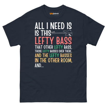 Navy unisex t-shirt featuring colorful text that reads "All I need is this lefty bass" with a graphic of a lefty bass guitar.