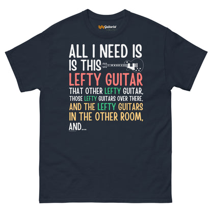 Navy unisex t-shirt featuring colorful text: "All I need is this lefty guitar" with lefty guitar graphic.